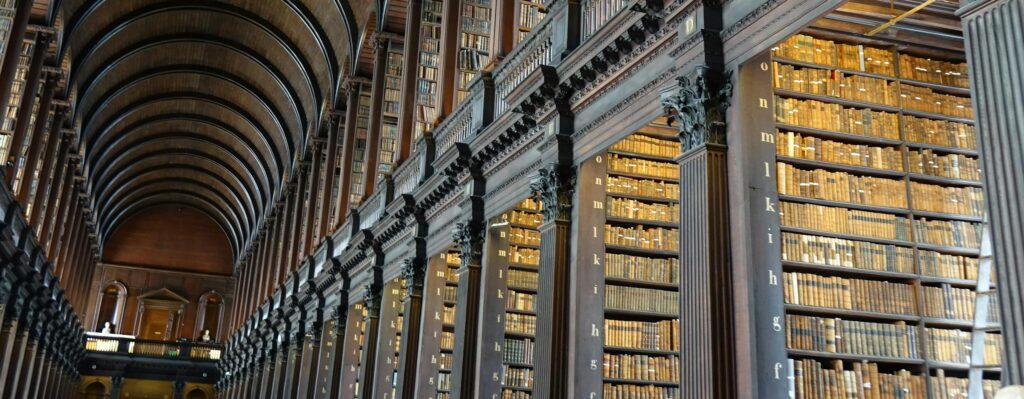 Expansive view of the historic Long Room library in Trinity College Dublin.